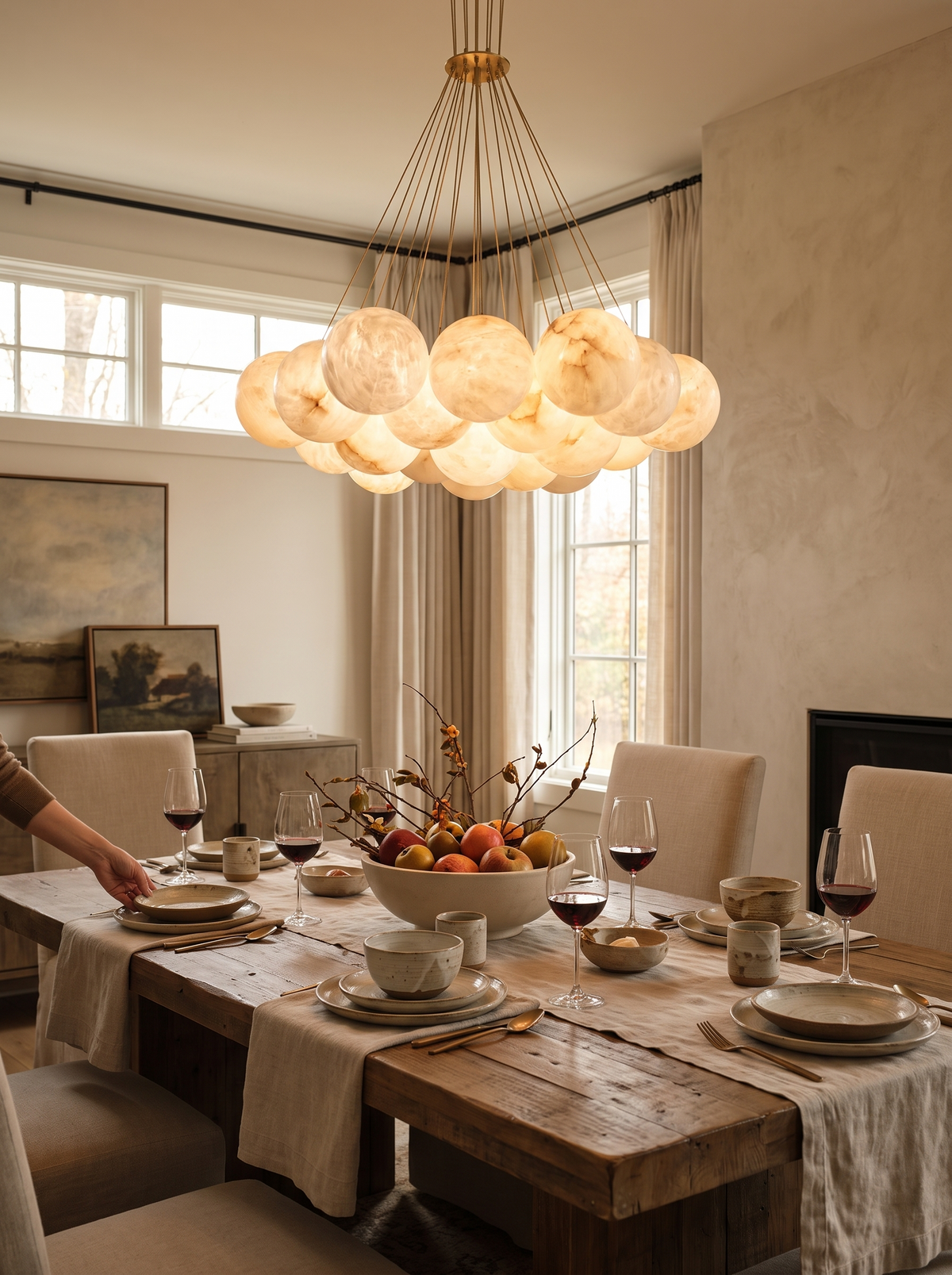 GOODNEST AURORA alabaster globe chandelier hung over a dining table
