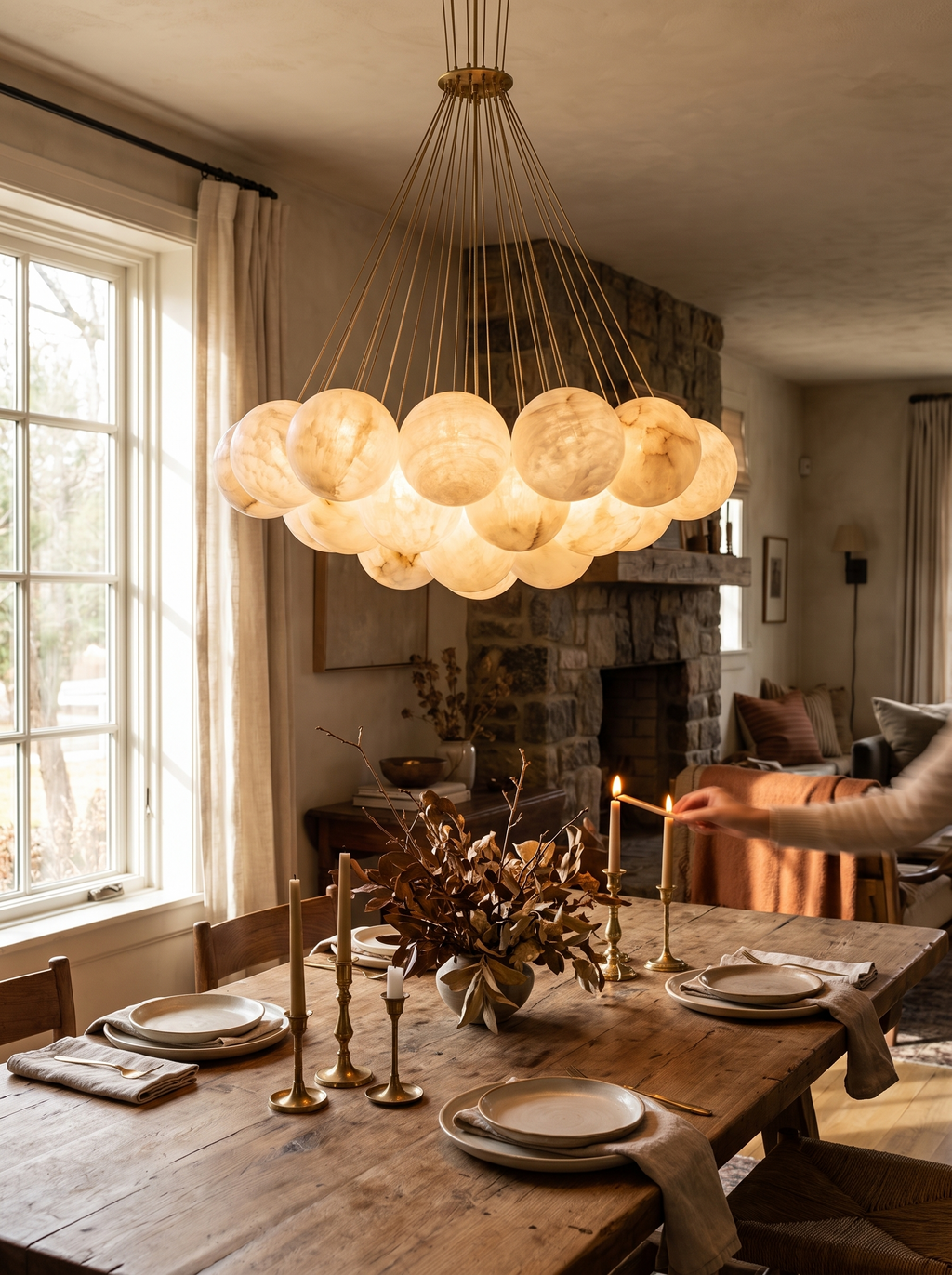 GOODNEST AURORA brass canopy and warm alabaster shades lit at night