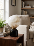 GOODNEST LUNA alabaster globe table lamp on a nightstand in daylight