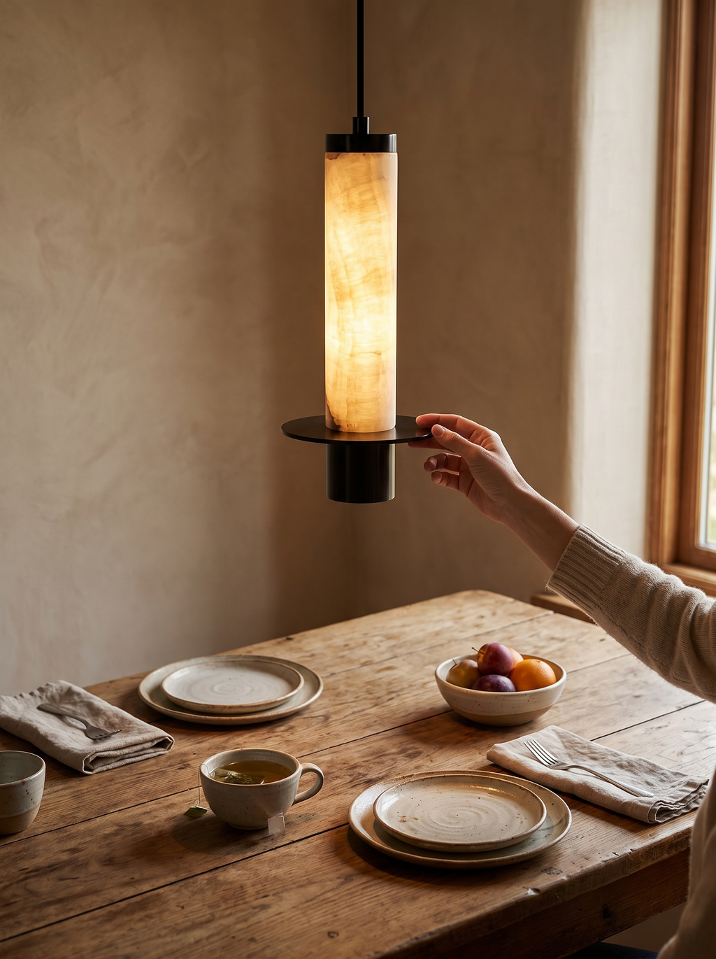 GOODNEST PLINTH pendants hung in a row over a kitchen island