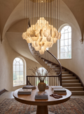 GOODNEST TORRENT alabaster cascade chandelier in a tall stairwell