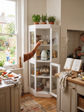 Tall white glass door pantry cabinet in a kitchen