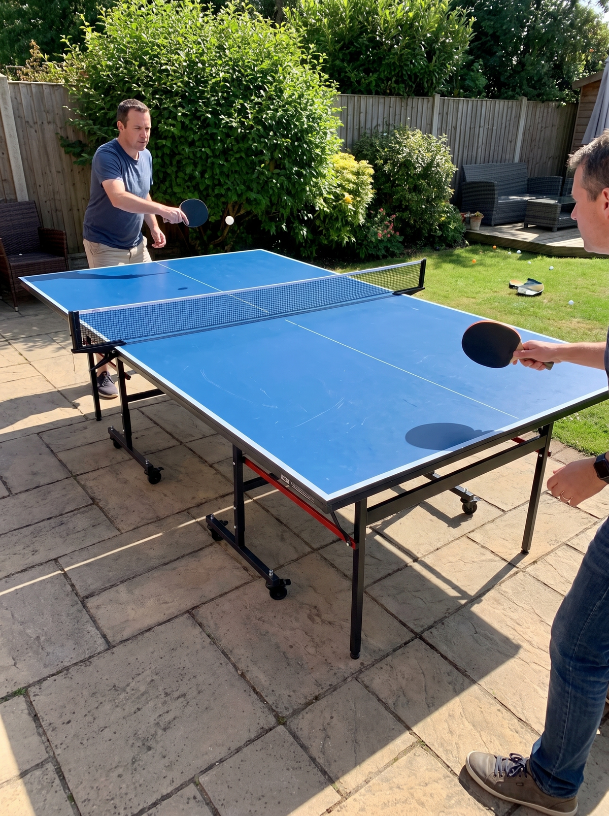 Table tennis rally in progress on a full size table