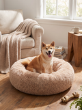 NEST calming round dog bed with a dog curled up